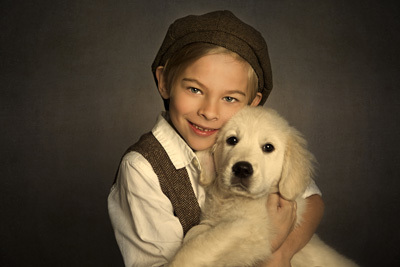 Boy in hat holding dog