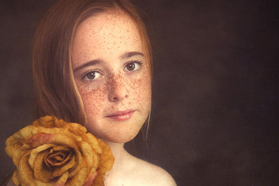 Portrait of a young girl with freckles and red hair