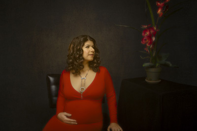 Maternity art portrait of woman in red dress
