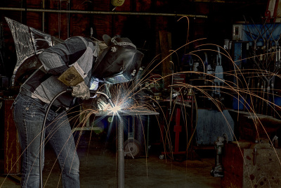 Wide side view of Kellan welding