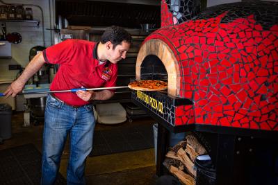 Pizzaiolo checking pizza