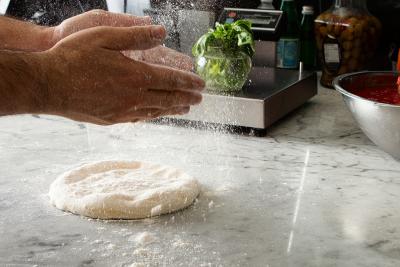Pizzaiolo preparing pizza dough from scratch