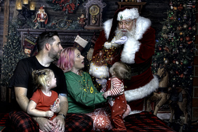 Santa blowing Christmas stars at family