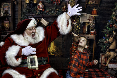 Santa giving Christmas stars to boy