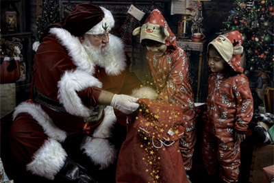 Two young girls looking in Santa's bag